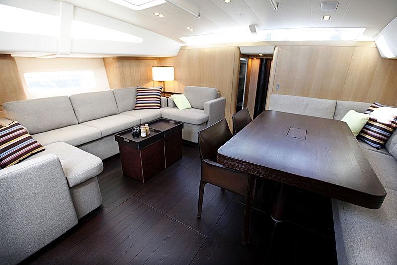 a living room with a couch and a table aboard YCH2 Yacht for Charter
