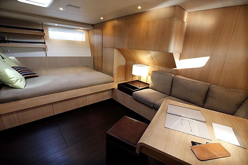 a room with a couch and a table aboard YCH2 Yacht for Charter