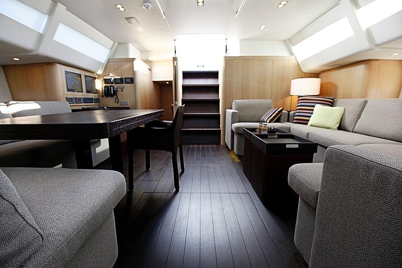 a room with a couch and a table and chairs aboard YCH2 Yacht for Charter