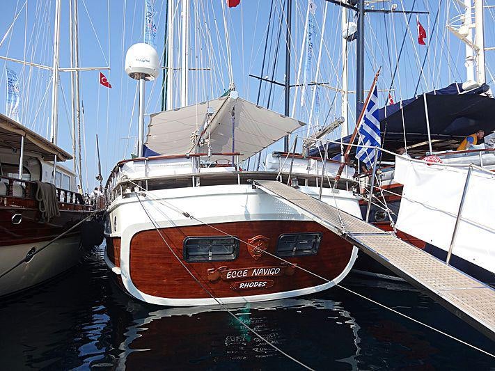 a boat docked at a pier aboard ECCE NAVIGO Yacht for Charter