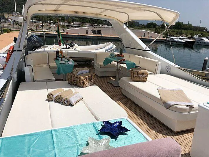 a boat with a couch and a table on it aboard PIERPAOLO IV Yacht for Charter