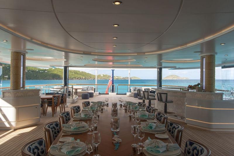a large room with tables and chairs aboard SOLANDGE Yacht for Charter