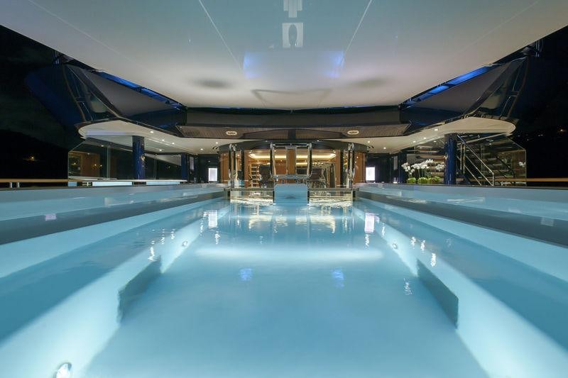 a swimming pool with a building in the background aboard SOLANDGE Yacht for Charter