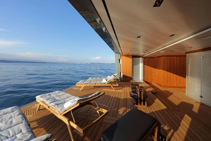a deck with a view of the ocean and the ocean aboard PLANET NINE Yacht for Charter