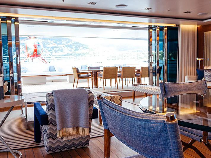 a room with chairs and tables aboard PLANET NINE Yacht for Charter