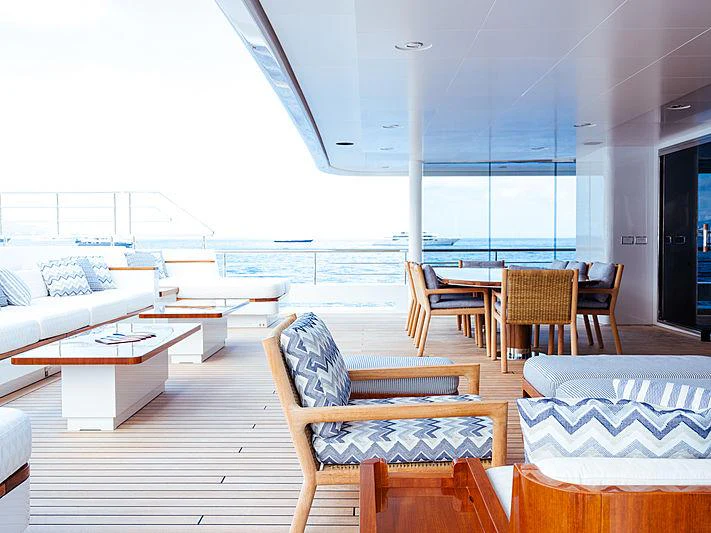 a room with a couch and a table and chairs aboard PLANET NINE Yacht for Charter