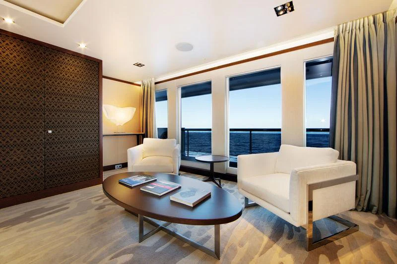 a living room with a large window aboard PLANET NINE Yacht for Charter