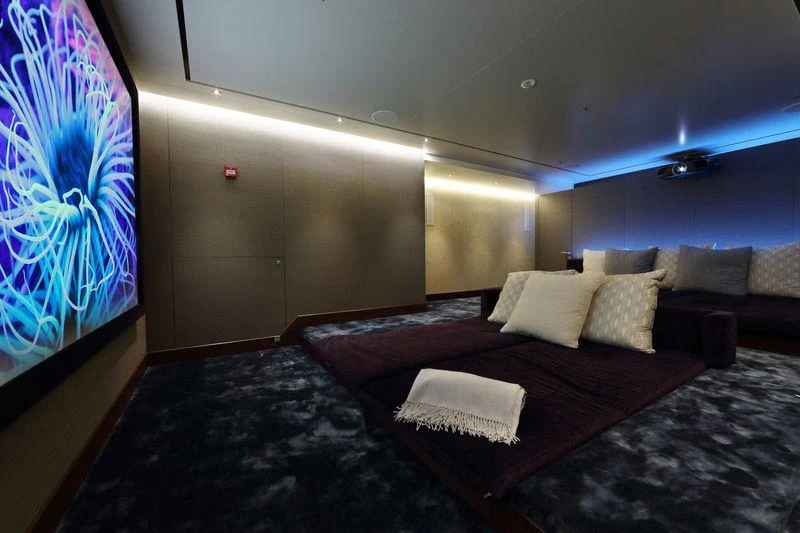 a room with a bed and a painting on the wall aboard PLANET NINE Yacht for Charter