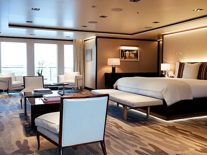 a hotel room with a bed and a desk aboard PLANET NINE Yacht for Charter
