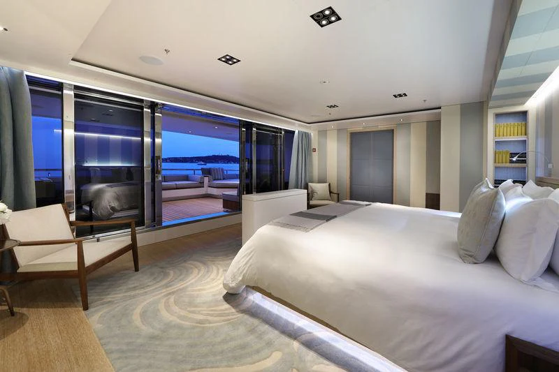 a room with a bed and a large window aboard PLANET NINE Yacht for Charter