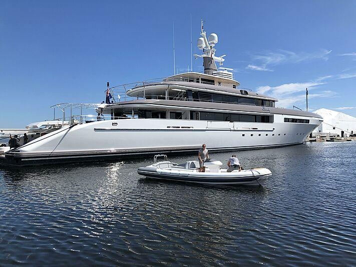a large white boat with a person standing on the front aboard ETERNITY Yacht for Charter