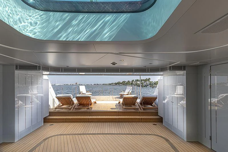 a deck with chairs and a pool aboard ILLUSION Yacht for Charter