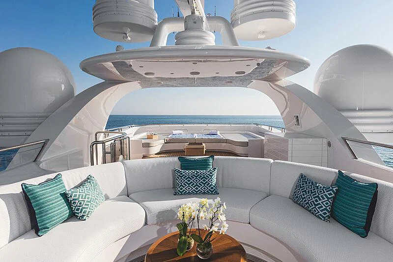 a large white yacht with blue pillows aboard MOCA Yacht for Charter