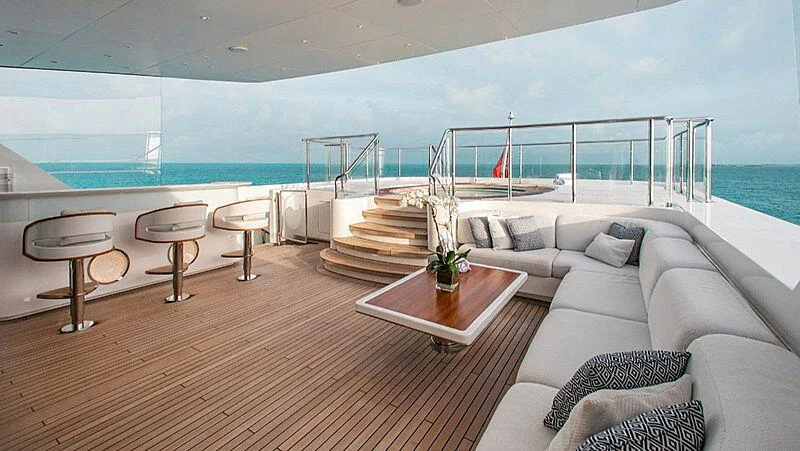 a living room with a large balcony aboard MOCA Yacht for Charter