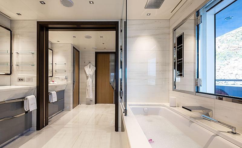 a bathroom with a bathtub and shower aboard ARTISAN Yacht for Charter