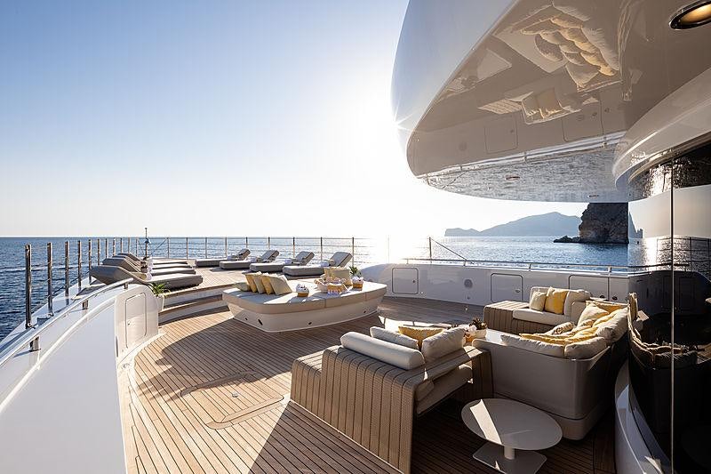 a room with a view of the ocean and a boat aboard ARTISAN Yacht for Charter