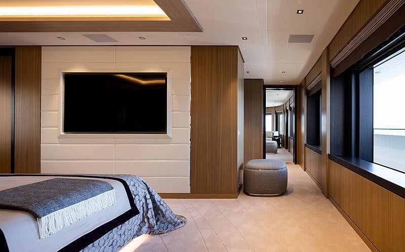 a bedroom with a bed and a tv aboard ARTISAN Yacht for Charter