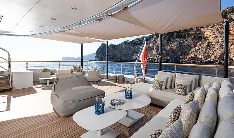 a living room with a large white sofa and a large flag aboard ARTISAN Yacht for Charter