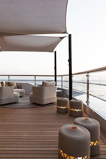 a table with a lamp and a window aboard ARTISAN Yacht for Charter