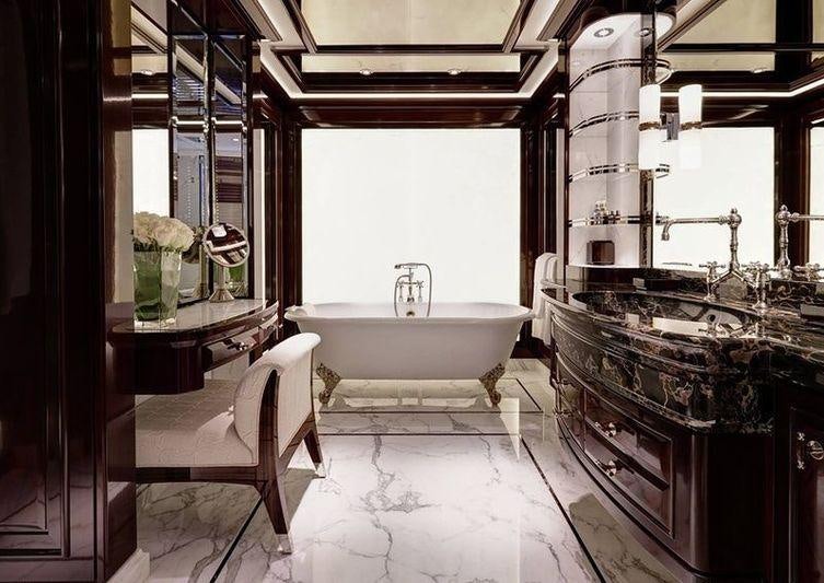 a bathroom with a tub sink and a mirror aboard ROCK.IT Yacht for Charter