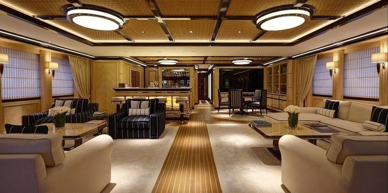 a large room with a table and chairs aboard ROCK.IT Yacht for Charter
