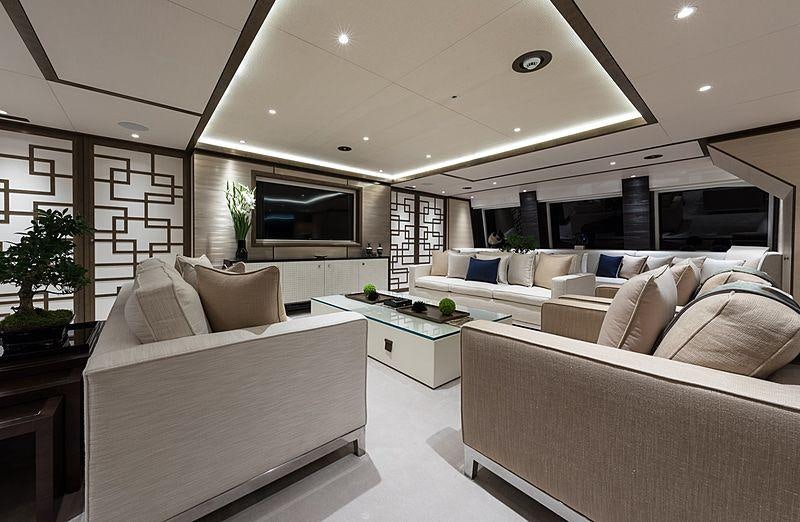 a room with white couches and a table aboard SAMURAI Yacht for Charter