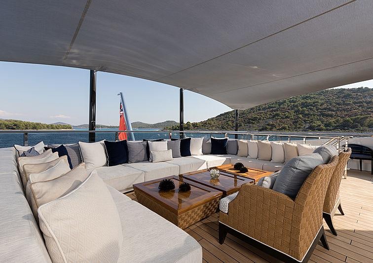 a large living room with a large window overlooking a city aboard SAMURAI Yacht for Charter