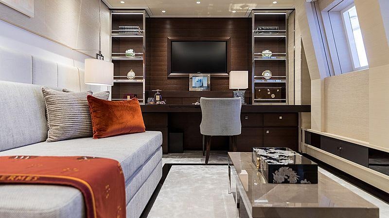 a living room with a bed and a tv aboard SAMURAI Yacht for Charter