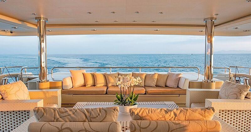 a room with a couch and a table and a large window aboard LIGHT HOLIC Yacht for Charter