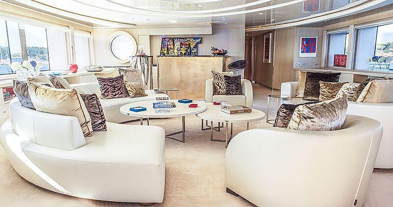 a living room with white furniture aboard LIGHT HOLIC Yacht for Charter