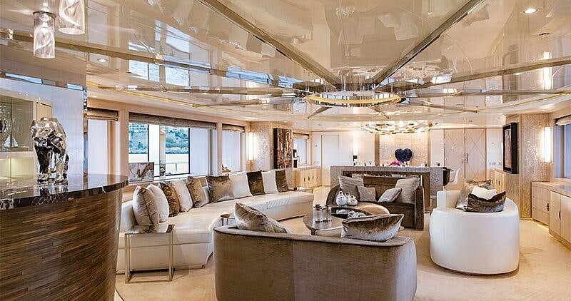a living room with a large chandelier aboard LIGHT HOLIC Yacht for Charter