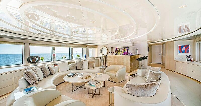 a living room with a large white chandelier aboard LIGHT HOLIC Yacht for Charter