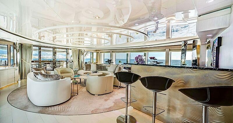 a large room with a table chairs and a large window aboard LIGHT HOLIC Yacht for Charter