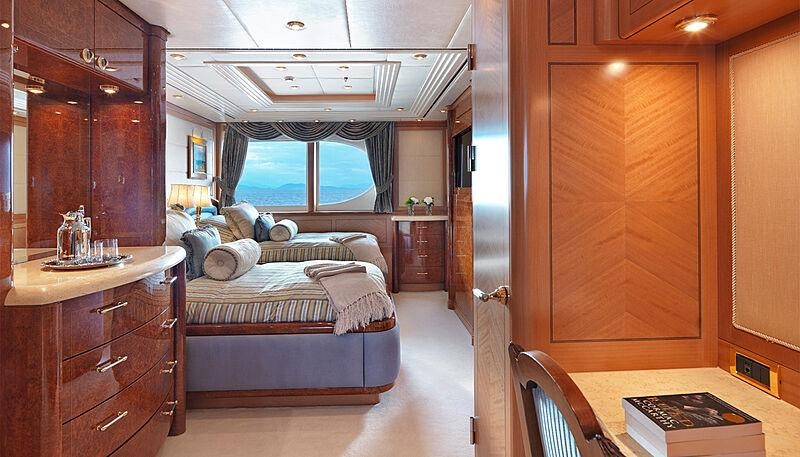 a bedroom with a bed and a dresser aboard CAPRI I Yacht for Charter