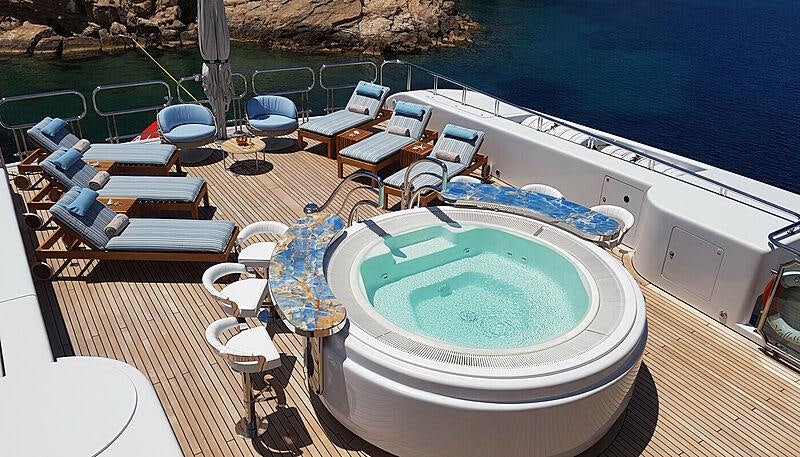 a swimming pool with chairs around it aboard CAPRI I Yacht for Charter