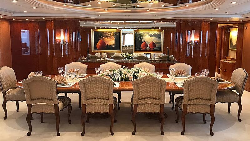 a room with a table and chairs aboard CAPRI I Yacht for Charter