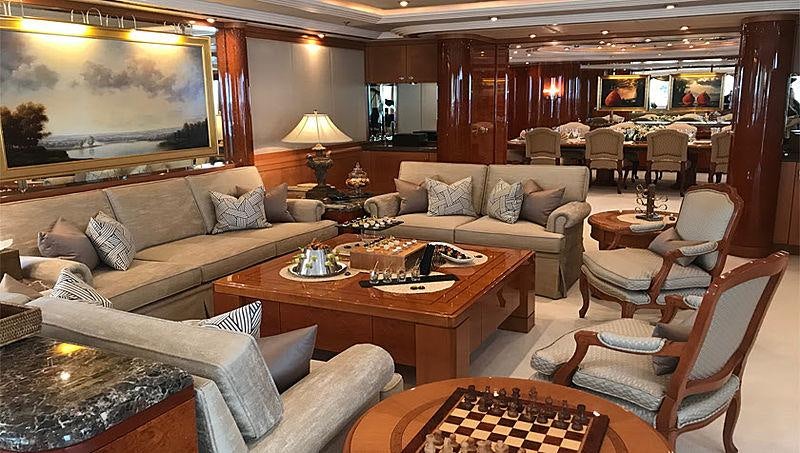 a living room with a large screen aboard CAPRI I Yacht for Charter