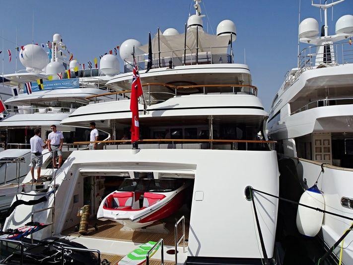 a boat docked with people walking on the deck aboard JAGUAR Yacht for Charter