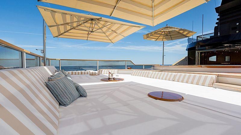 a room with a large bed and umbrellas aboard TAIBA Yacht for Charter