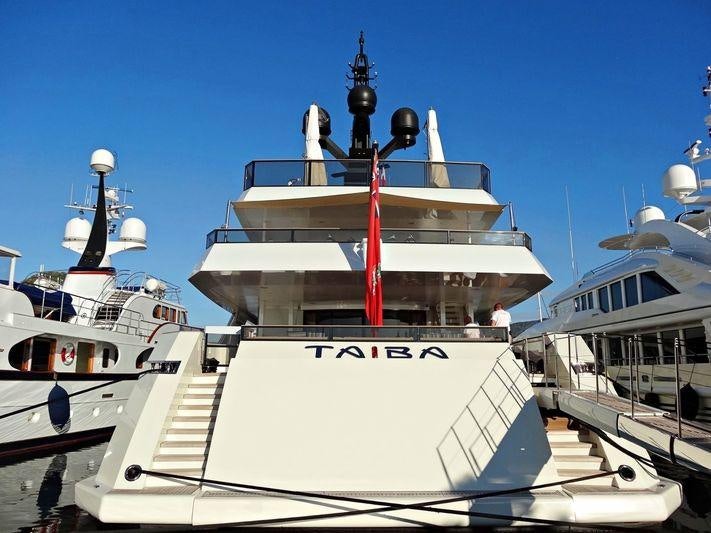 a large boat docked at a pier aboard TAIBA Yacht for Charter