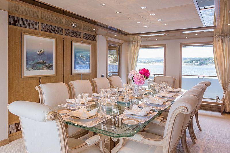 a dining room with a table set for a dinner aboard FRIENDSHIP Yacht for Charter
