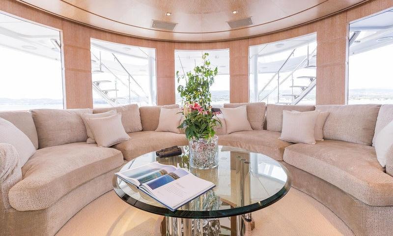 a living room with a vase of flowers on a table aboard FRIENDSHIP Yacht for Charter