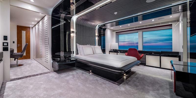 a room with a bed and a chair aboard EUPHORIA II Yacht for Charter