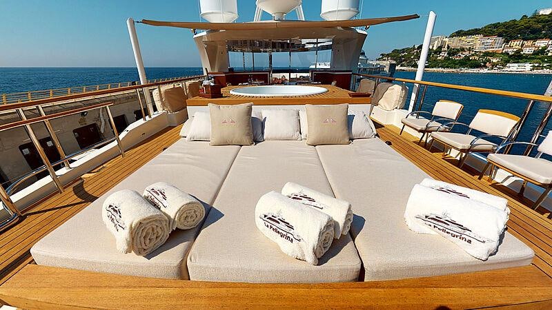 a lounge area with a lounge chair and a large body of water aboard LA PELLEGRINA 1 Yacht for Charter
