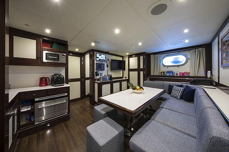 a living room with a couch and a coffee table aboard MAXIMILIAN MMIV Yacht for Charter