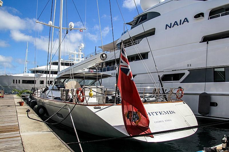 a large white boat with a red and white stripe on the front aboard MES AMIS Yacht for Charter