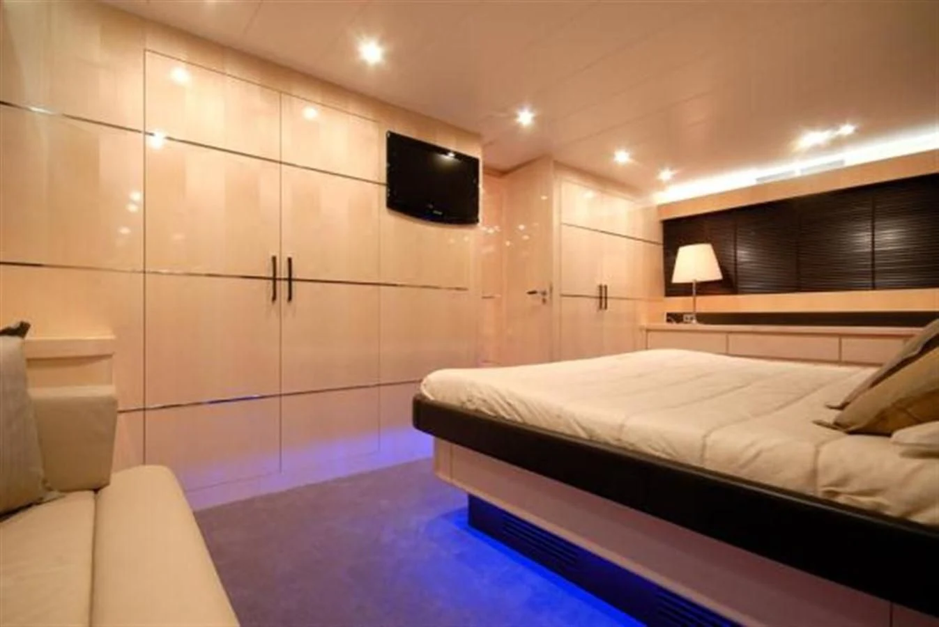 a room with a bed and a television aboard SANS SOUCI Yacht for Sale