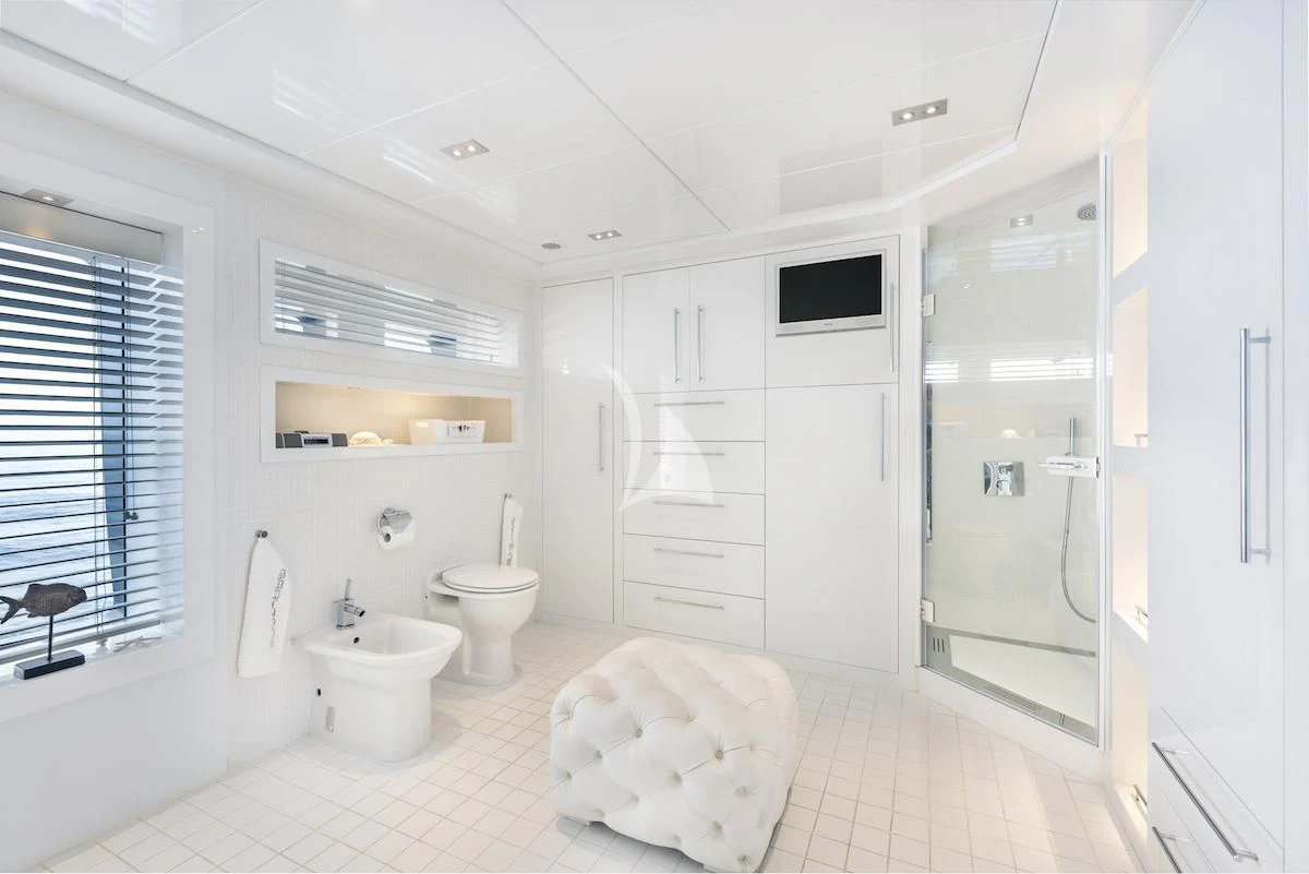 a bathroom with a toilet and a sink aboard THANUJA Yacht for Sale