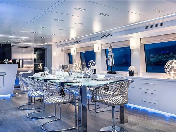 a large room with a table and chairs aboard THANUJA Yacht for Sale