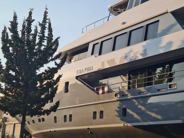 a large white building with a tree in front of it aboard THANUJA Yacht for Sale